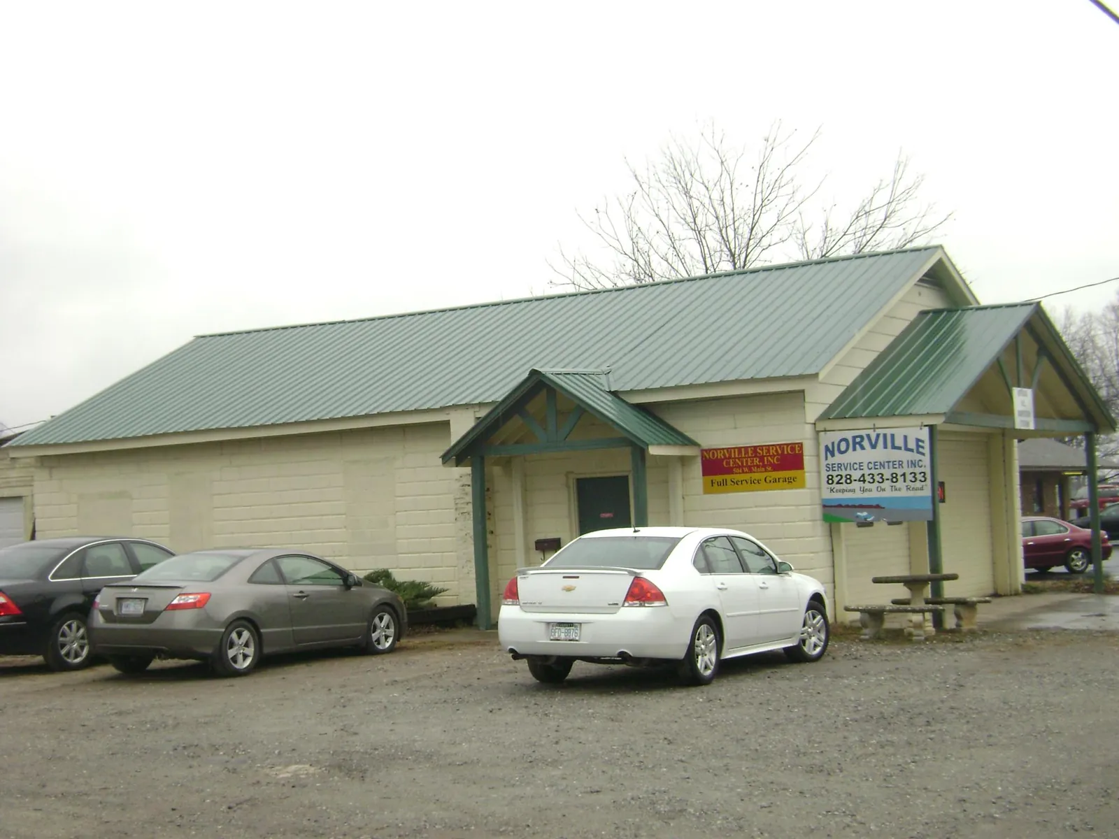 Green metal roof on a service garage with a covered entry in Burns